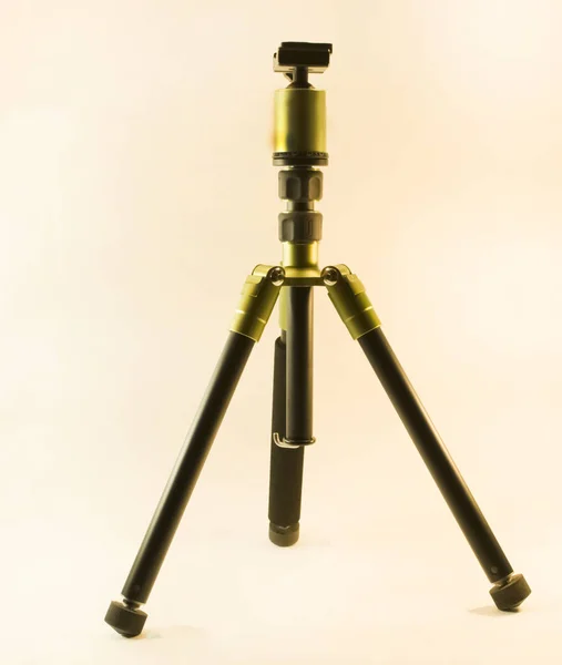 tripod for SLR camera stands upright on a white background.