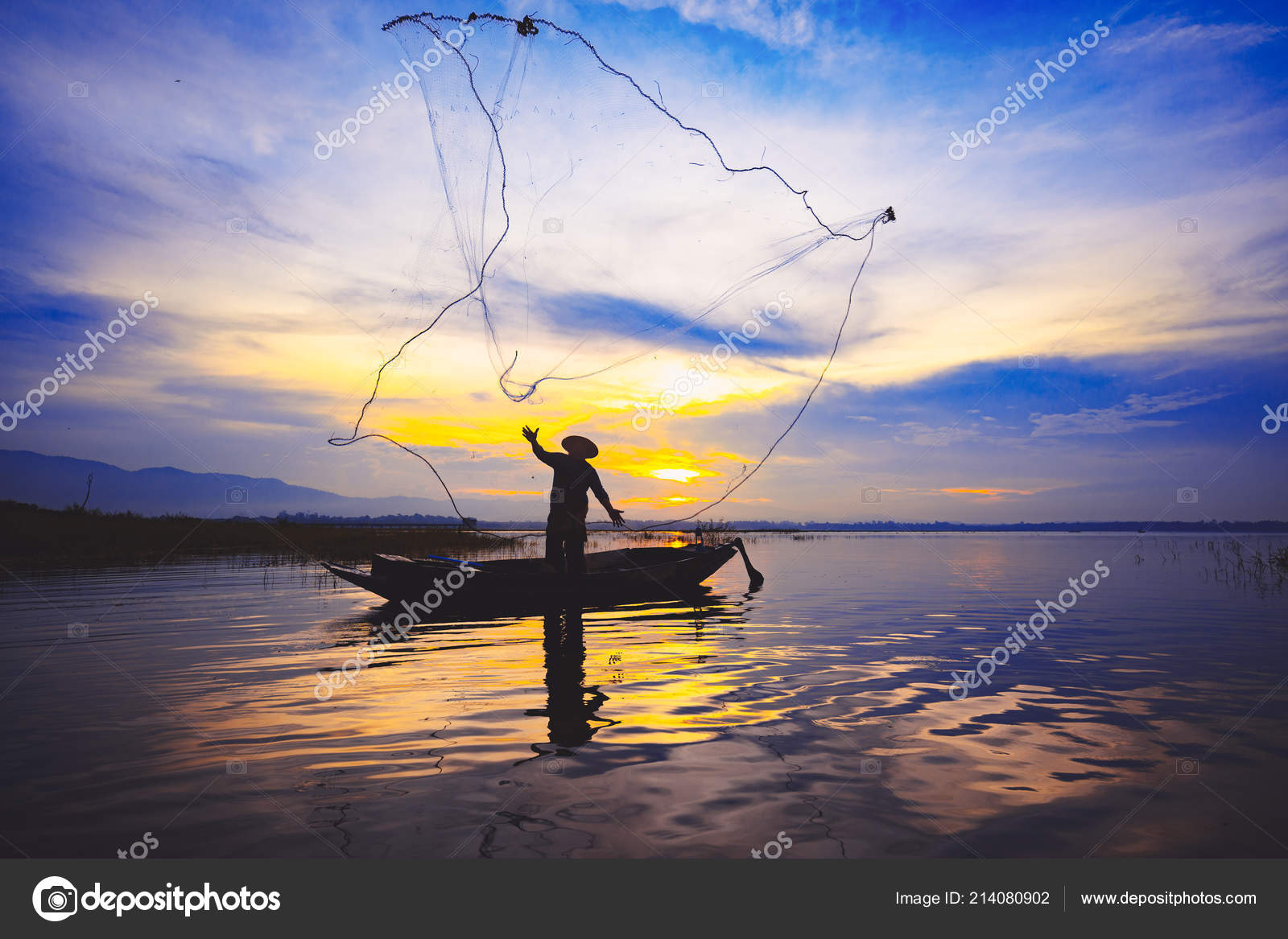 Silhouette Fisherman Throwing Fishing Net Sunrise Stock Photo by