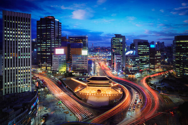 Sungnyemun Gate or Namdaemun Gate at Namdaemun market with light trails of car at night in Seoul, South Korea