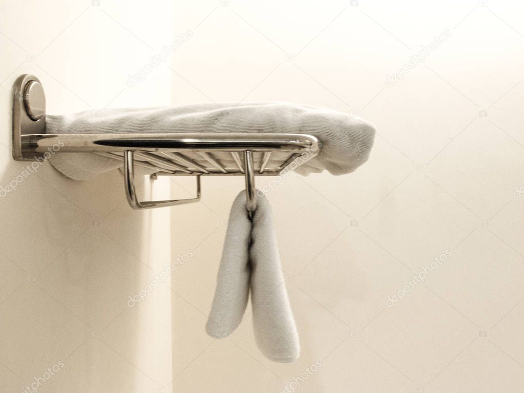 White Terry Towels Hanging on the wall in the bathroom / side view