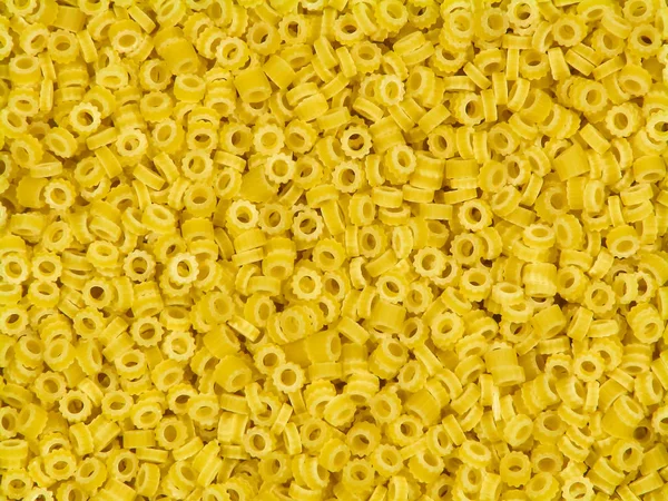 Anelli yellow italian pasta close-up background — Stock Photo, Image