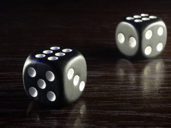 Table gambling with dice in the evening with dim light on a dark background