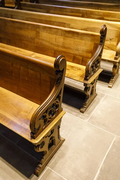 Old wooden benches in row in a church — Stock Photo, Image