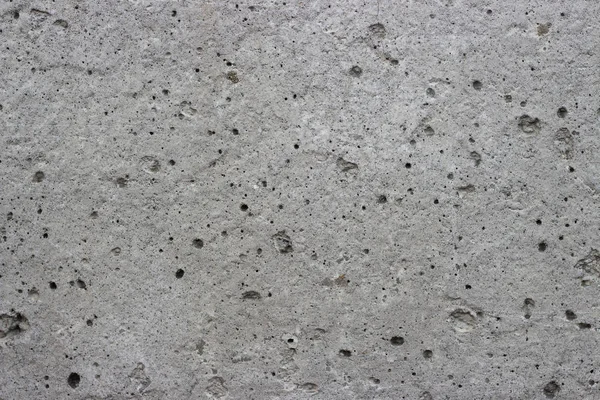 Parede cinza de concreto com poros, texturas, fundo . — Fotografia de Stock