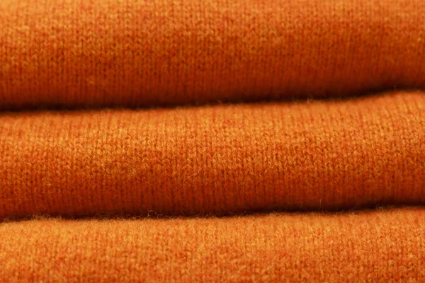 Stack of trend Russet Orange woolen sweaters close-up, texture, background — Stock Photo, Image