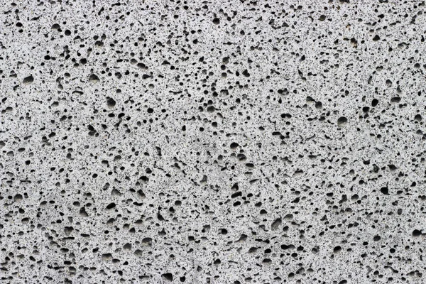 灰色の多孔質フォーム クローズ アップ、テクスチャの背景 — ストック写真