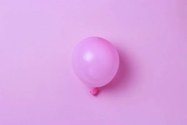 Three Balloons on a pastel pink background close-up, holiday concept