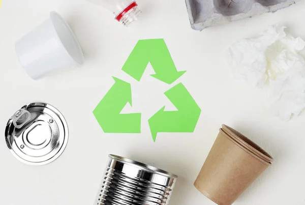 Green recycle garbage symbol and plastic, iron garbage on white background, top view.