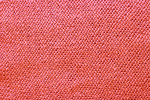 Knitted surface trend coral color close-up, fashionable background — Stock Photo, Image