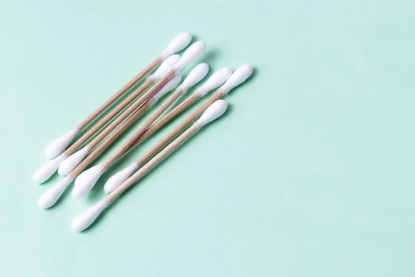 Cotton swabs isolated on green background, concept no plastic