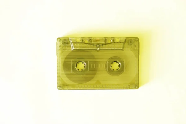 Retro audio cassette, close-up on a yellow background, vintage concept. — Stock Photo, Image