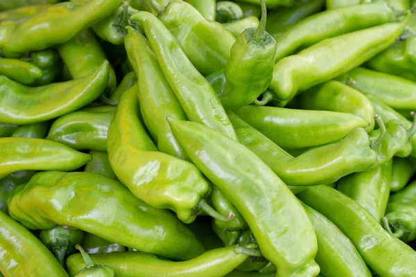 Large amount of green chili peppers, a natural background, top view