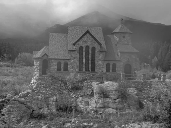 a chapel in the rocky mountains black and white