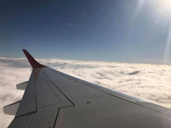 view from the plane to the wing and sky