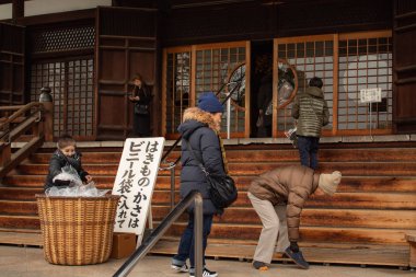 Osaka, Japonya - 29 Ocak 2018: Japonca tapınak Osaka girmeden önce alarak Ayakkabı insanlar