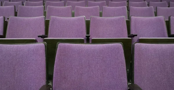 Empty rows of seats in auditorium or concert hall.Close up,selective focus. Concept of quarantine,curfew,cancellation of mass events to prevent coronavirus,losses of organizers in entertainment sector