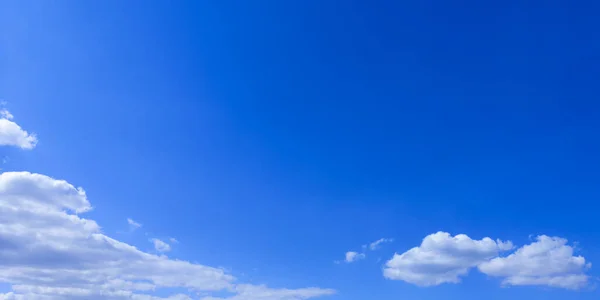 Wide blue sky with white weightless cloud on beautiful sunny day.Horizontal backdrop,banner for website,text.Copy space — Stock Photo, Image