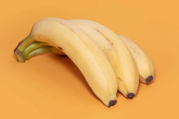 Bunch of bananas on yellow background.