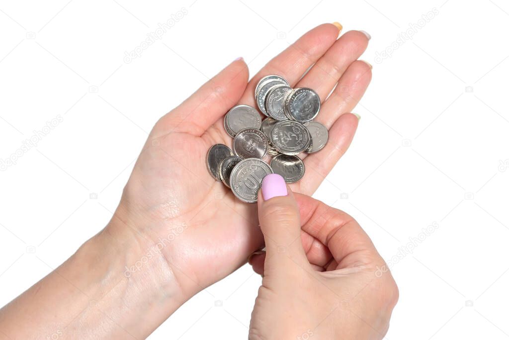 woman's hand holding Ukrainian coins isolated on white background.