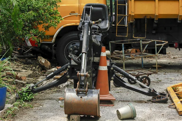 Old backhoe is parked, no maintenance.