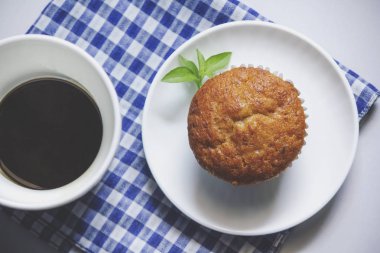 Kumaş üzerine beyaz cam ve muz pasta siyah kahve.