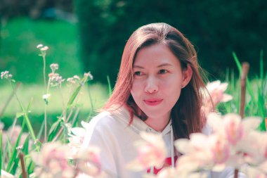 Women are watching the pink orchid in nature