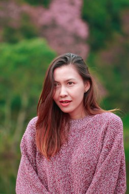 Women wearing pink shirts are happily smiling.