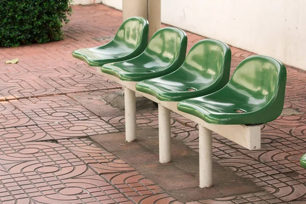 Green plastic chair at the bus stop For passengers waiting