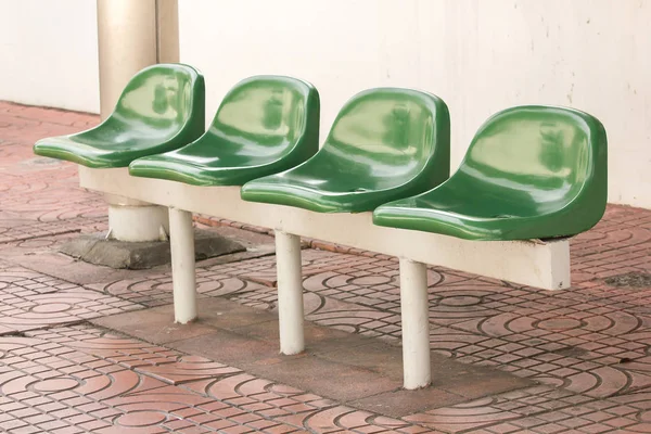 Green plastic chair at the bus stop For passengers waiting