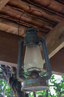 Eski mavi kasırga lambası kiriş üzerinde asılı