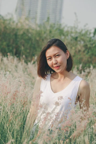 Woman Sitting Grass Field Happy Smile Swaying Hair — 스톡 사진