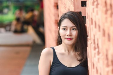 Kadınlar eski tuğla duvarlara karşı duruyorlar..