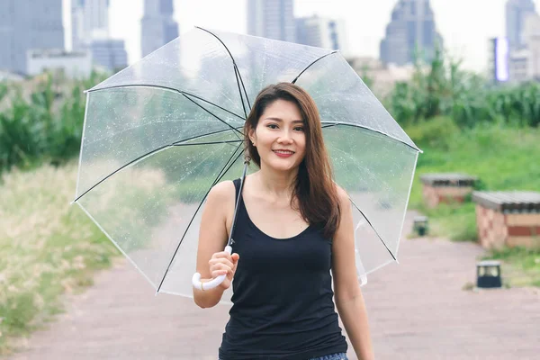 Women walking the umbrella On the path in the park