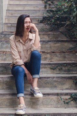 Kadın zevkle eski merdivende oturdu.