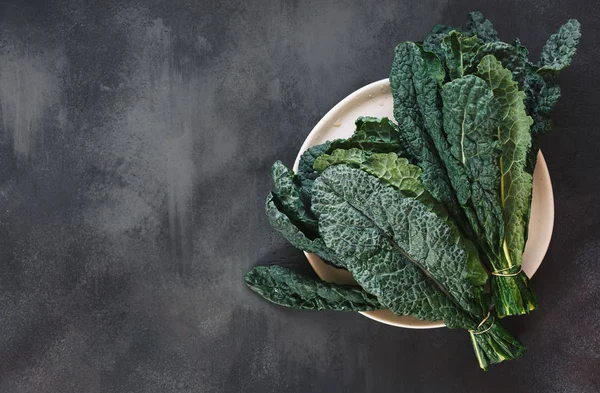 Fresh Tuscan Kale Leaves White Plate Rustic Dark Background Top — Stock Photo, Image