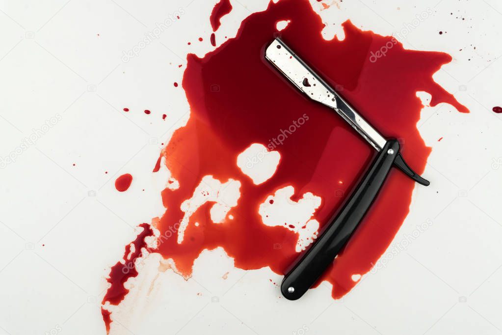 crime scene concept, a vintage straight razor in pool of blood