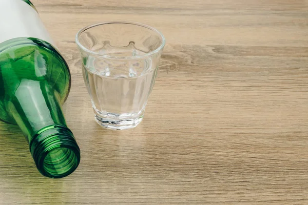 木製のテーブルの上のガラスの焼酎瓶のクローズ アップ 焼酎はほとんど無色の蒸留酒 韓国で人気のあるお酒 — ストック写真