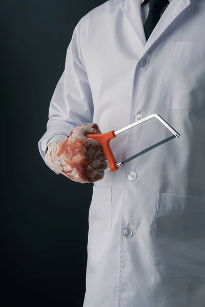 Doctor Wearing Bloody Gloves Hand Saw Dark Background — Stock Photo, Image