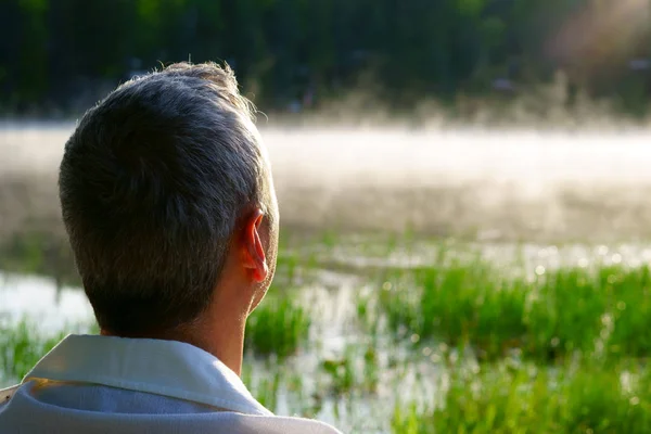 Meditation by the river. Early morning. Sunrise with some mist on the lake in Canada.