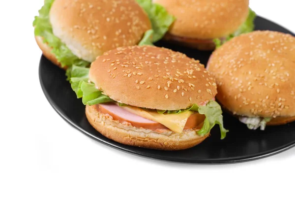 Hambúrguer com salsicha e queijo com alface fresca. Quatro hambúrgueres na placa preta. Isolado. Vista superior — Fotografia de Stock