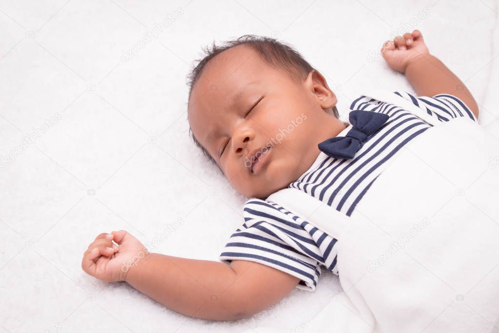 newborn asian boy baby sleeping on white furry cloth