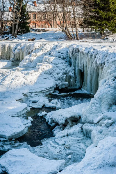 Famous waterfall in Estonia. Keila-Joa Schloss Fall. Partly frozen waterfall by winter. Estonia.
