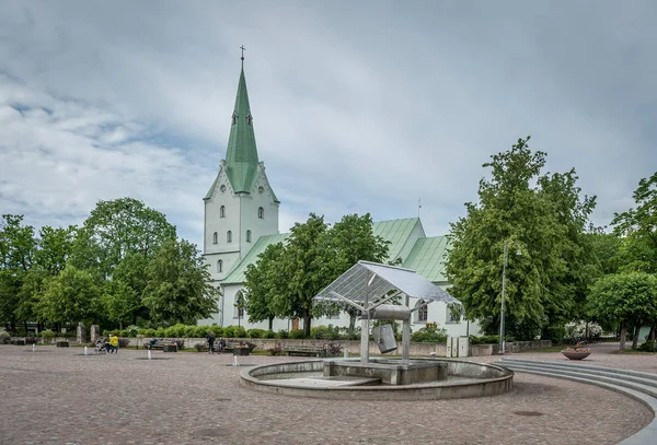 Dobele Evangelical Lutheran Church and  the largest well in the city square. Dobele, Latvia.