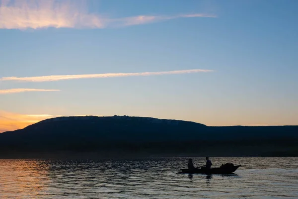 Fishermen on the boat during sunset. boat sunset lake