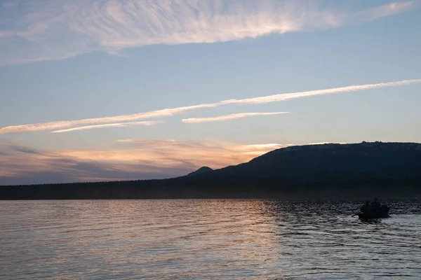 Fishermen on the boat during sunset. boat sunset lake