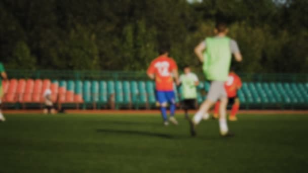 Fußballer attackiert und passt den Ball, Amateurfußballspiel im kleinen Stadion in Zeitlupe, verschwommen — Stockvideo