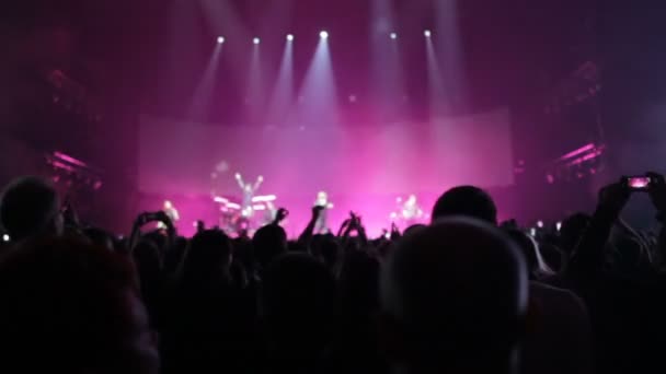 Глядачі на концерті розмахували руками, на сцені легке шоу, концерт — стокове відео