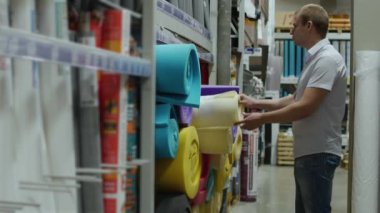 Erkek müşteri köpük kauçuk izolasyon İnşaat malzemeleri dükkanında seçer.