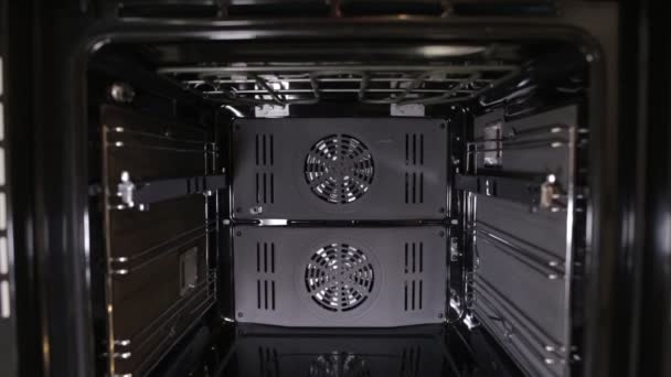 Black stylish and modern gas stove with convection, close-up, view inside, grill — Stock Video