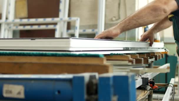 Production and manufacturing of pvc windows, male worker produces pvc window assembly collects sash windows, pvc profile, equipment — Stock Footage Production and manufacturing of pvc windows, male worker produces pvc window assembly collects sash windows, pvc profile, equipment Stock Video